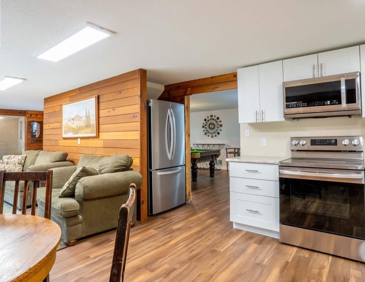 Open-plan kitchen with stainless steel appliances and living area