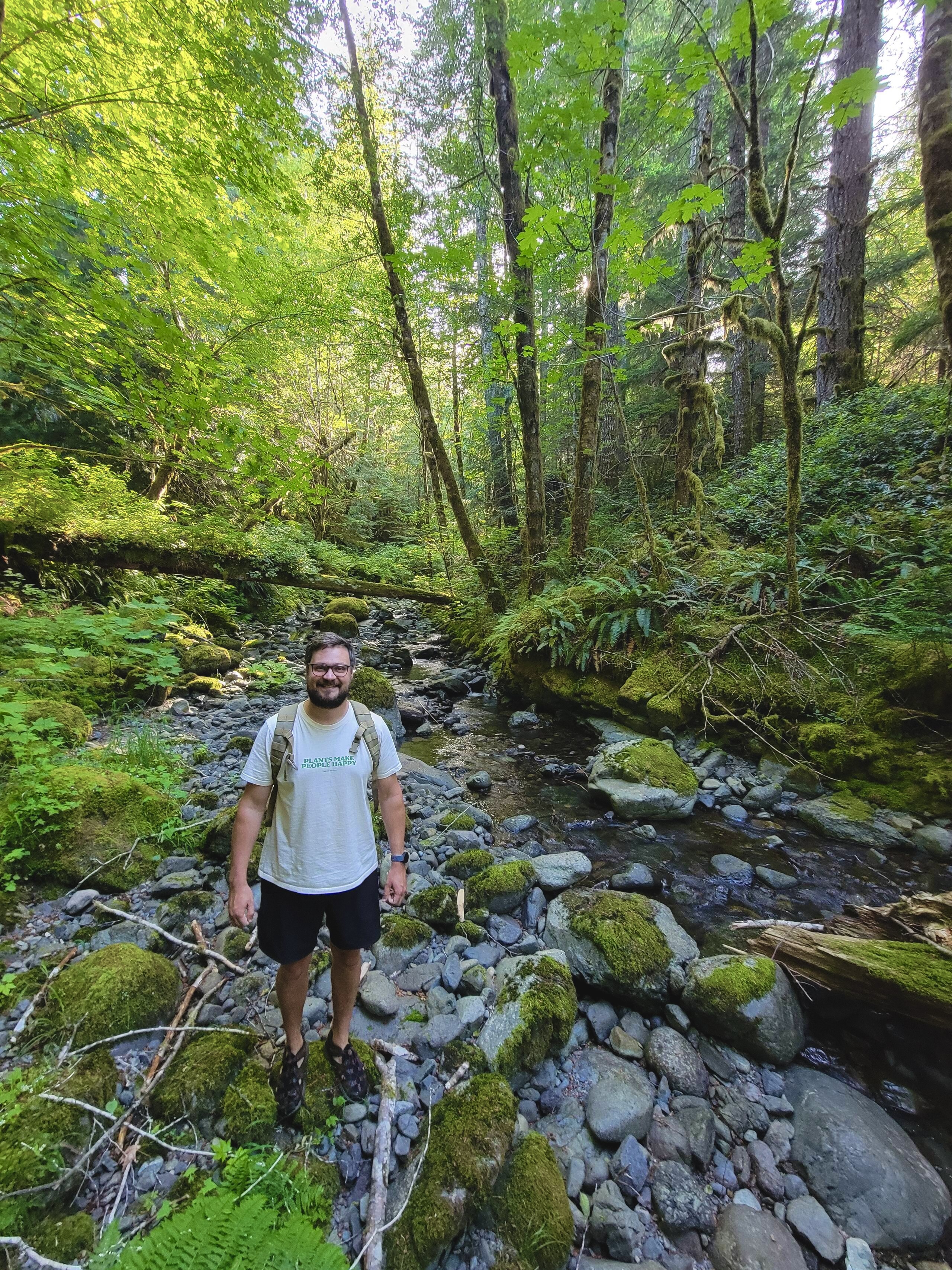 Francis guiding a forest therapy session among the trees at Riverdaughter Acres