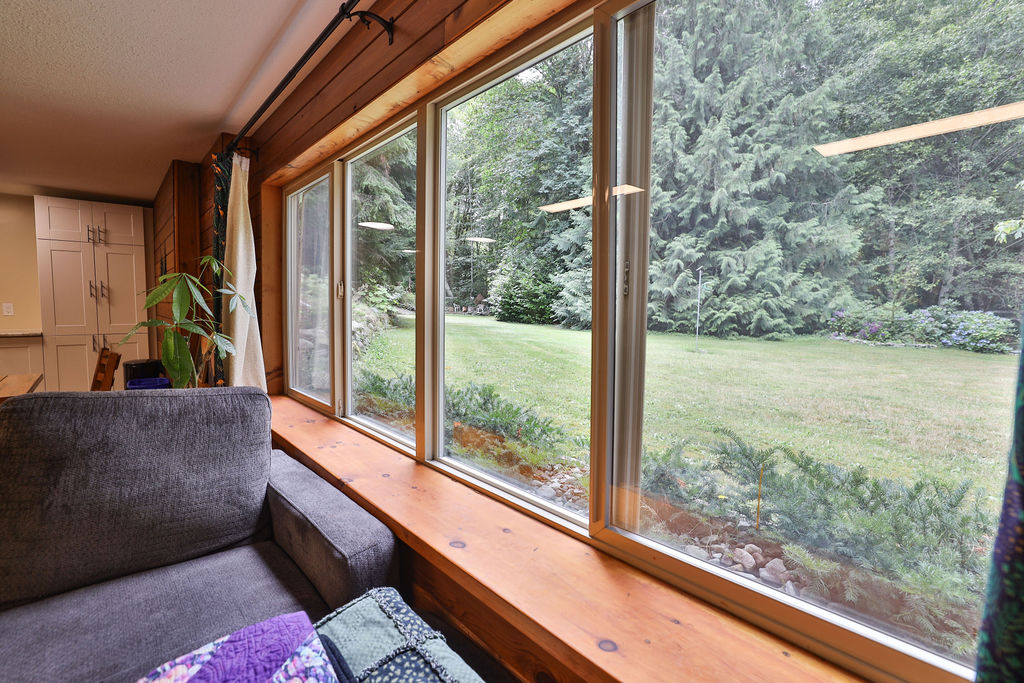 Window seat looking onto lawn and forest at Riverdaughter Acres